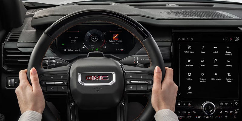 Driver cockpit of the 2026 GMC Acadia featuring advanced safety and driver assistance technology