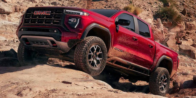 2026 GMC Canyon conquering rugged rocky terrain with exceptional off-road performance and capability