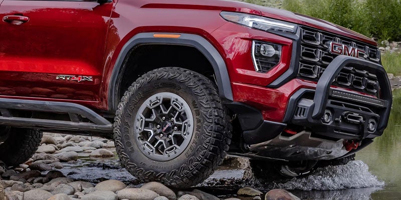 2026 GMC Canyon trim showcasing rugged off-road suspension, skid plates, and aggressive all-terrain tires