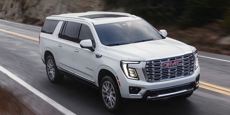 2026 GMC Yukon full-size SUV driving on a scenic highway near Paris, TN