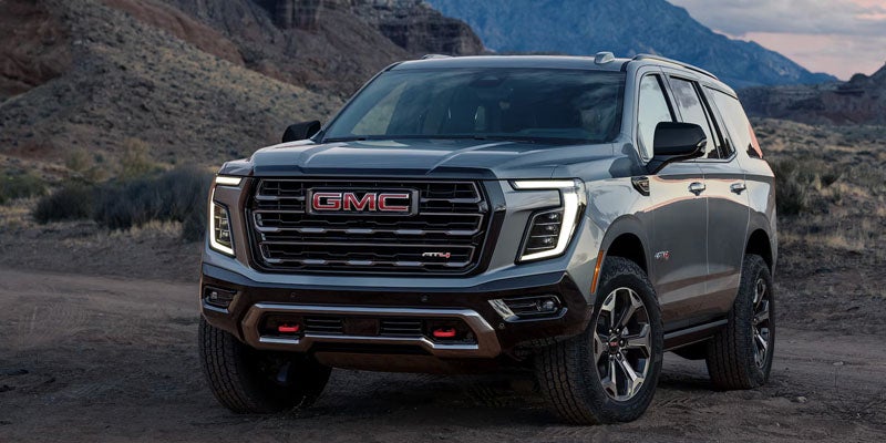2026 GMC Yukon driving on a scenic road near Paris, TN